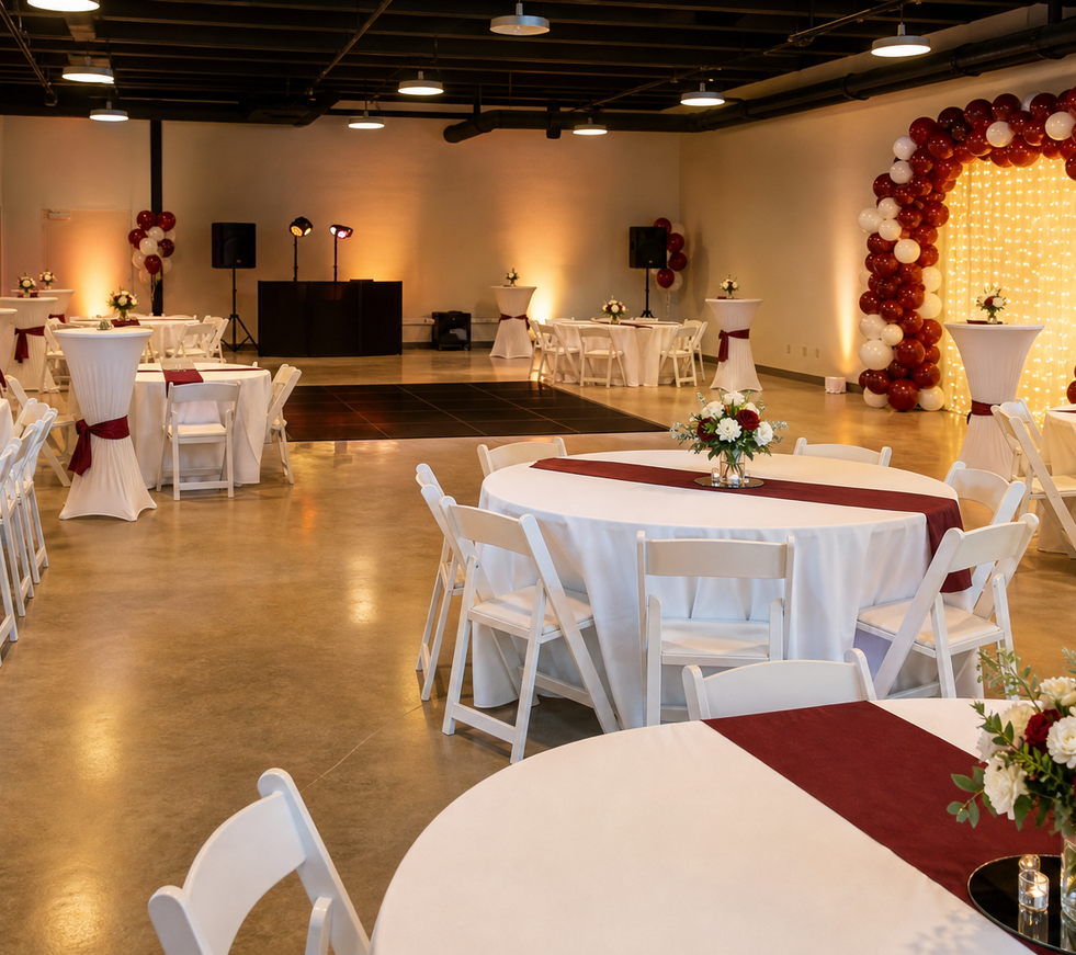 Finished venue with coordinated tables, chairs, linens, décor, and event lighting
